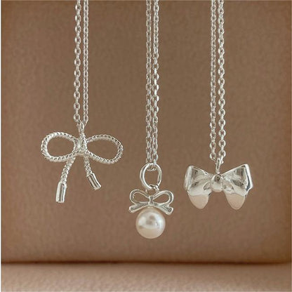 Petite Bow & Pearl-Accent Necklace in Gold-Tone Silver - view 9